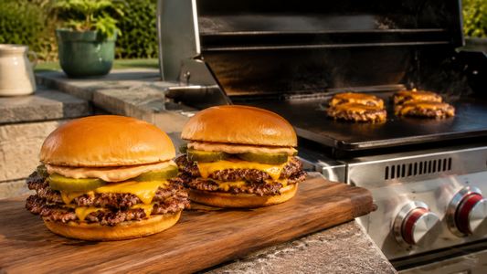 Double smash burgers made outdoors on a gas grill