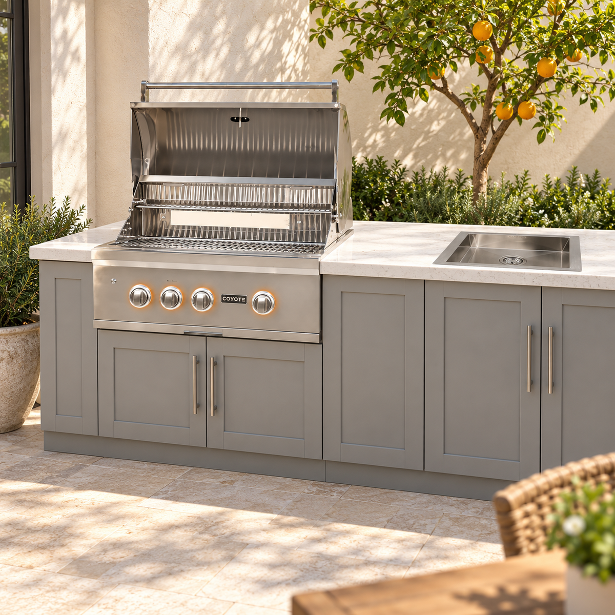 Coyote Cook & Clean Package – 30" Grill & Drop-In Sink installed in an outdoor kitchen; cabinetry and setting shown for inspiration