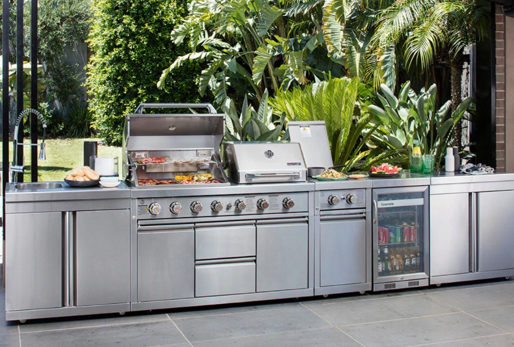 Stainless Steel Modular Outdoor Kitchen with Built in Double Grill, Refrigerator, Side Burner, Sink and storage cabinets.